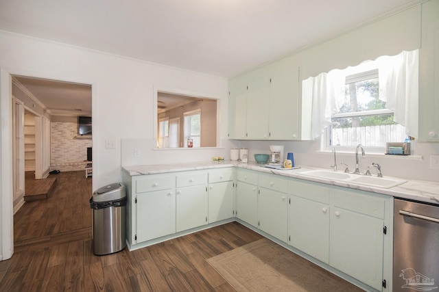 kitchen featuring dishwasher, light countertops, a sink, and dark wood finished floors