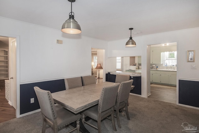 dining area with dark colored carpet, visible vents, and a healthy amount of sunlight