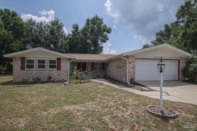 single story home featuring a garage and a front lawn