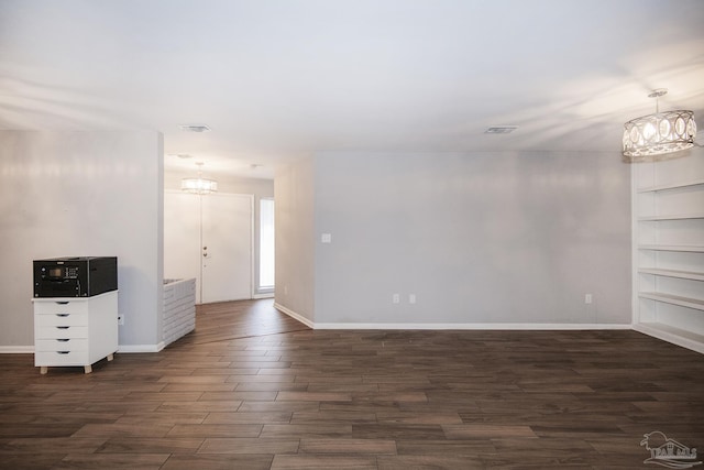 foyer featuring baseboards, dark wood-style flooring, visible vents, and a notable chandelier