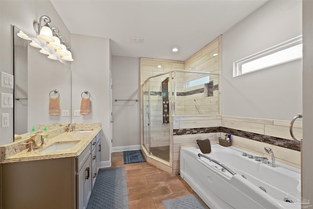 bathroom with a stall shower, a garden tub, and a sink