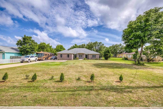 single story home with a front lawn and driveway