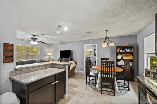 dining area with light tile patterned floors, ceiling fan, and a wealth of natural light