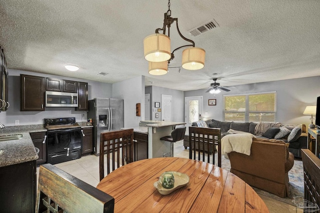 dining room featuring visible vents, a textured ceiling, ceiling fan, and light tile patterned floors