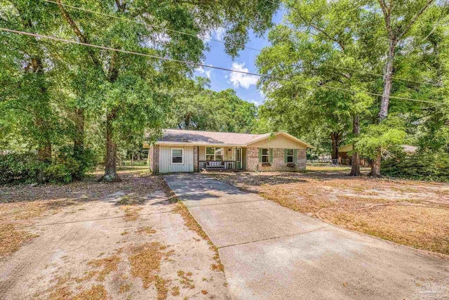 single story home featuring covered porch and driveway