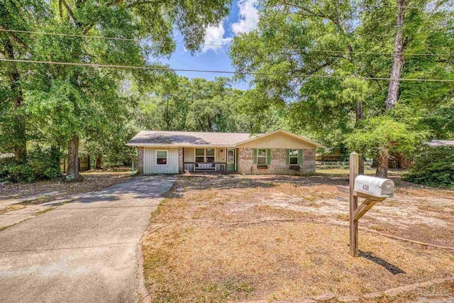 single story home featuring a porch and driveway