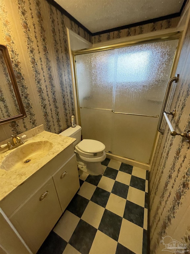 full bath featuring tile patterned floors, toilet, a textured ceiling, a shower stall, and vanity