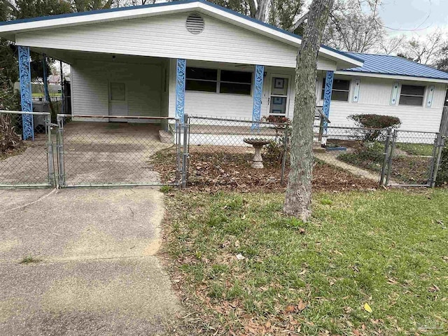 view of front of home featuring an attached carport, a gate, driveway, a fenced front yard, and metal roof