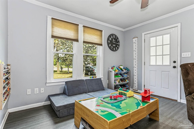 rec room with crown molding, baseboards, a ceiling fan, and wood finished floors