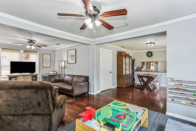 living area with visible vents, a ceiling fan, baseboards, and wood finished floors