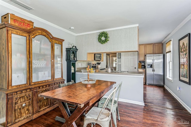 dining space with crown molding, baseboards, dark wood finished floors, and visible vents
