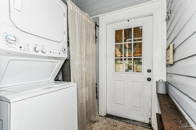 washroom featuring laundry area and stacked washer and clothes dryer