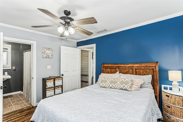 bedroom with ceiling fan, visible vents, crown molding, baseboards, and dark wood-type flooring