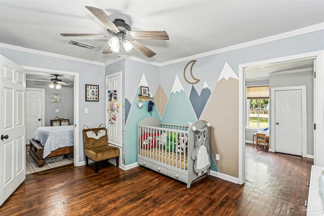 bedroom featuring visible vents, ornamental molding, wood-type flooring, baseboards, and ceiling fan