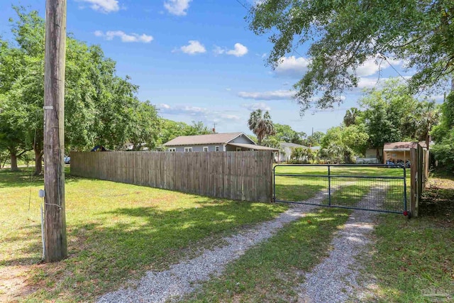 view of yard with fence and a gate