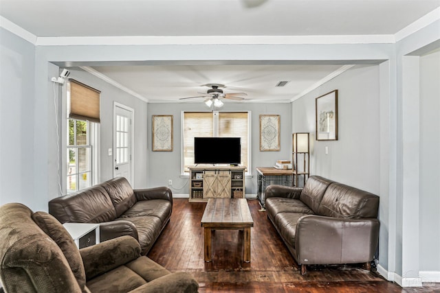 living area featuring ceiling fan, visible vents, crown molding, baseboards, and dark wood-type flooring
