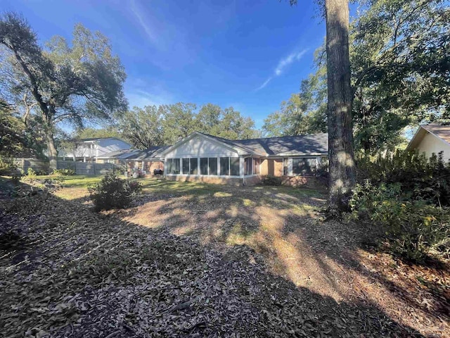 rear view of property with a sunroom