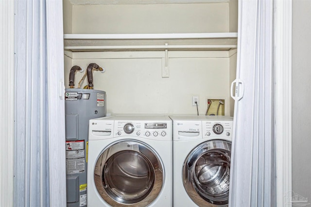 laundry area with washing machine and clothes dryer and water heater