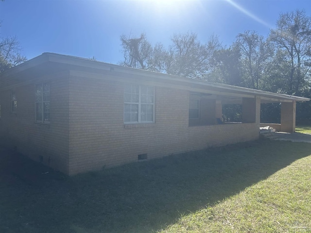 view of home's exterior with crawl space, brick siding, and a lawn