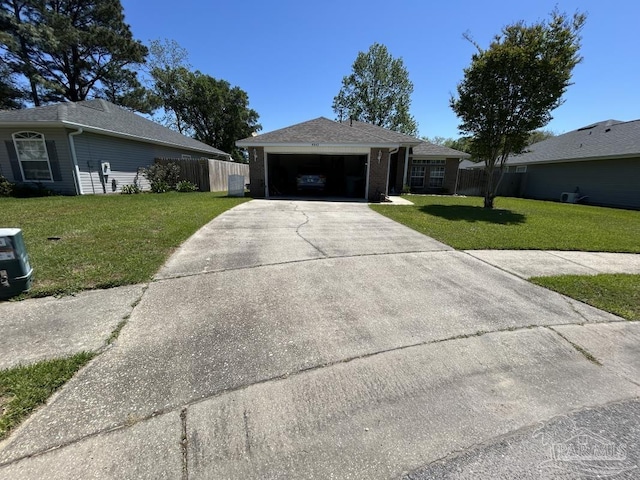 ranch-style home with an attached garage, a front lawn, fence, and concrete driveway