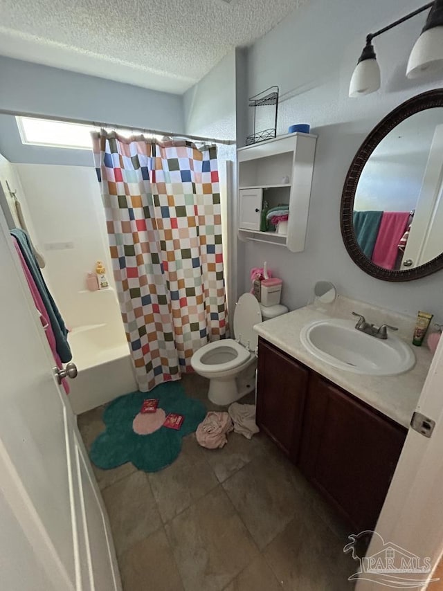 full bath featuring tile patterned flooring, vanity, toilet, a textured ceiling, and a shower with curtain