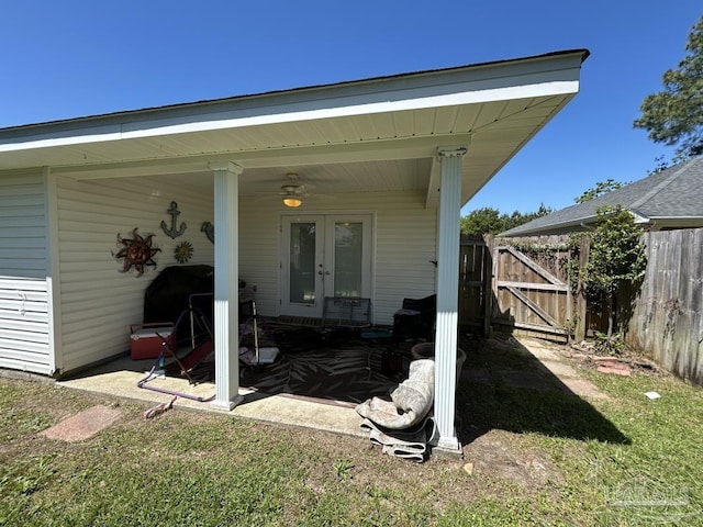 rear view of property with french doors, fence, and a gate