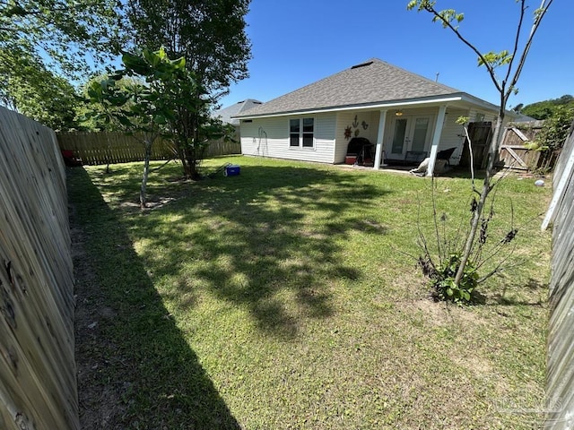 exterior space with french doors and a fenced backyard