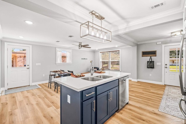 kitchen with dishwasher, a kitchen island with sink, light hardwood / wood-style flooring, and blue cabinets