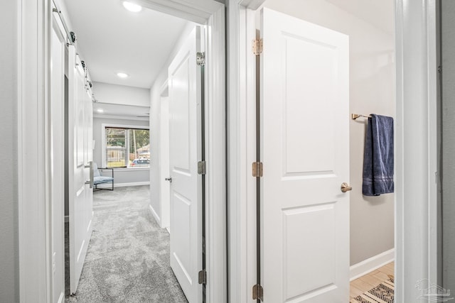 hallway with light colored carpet