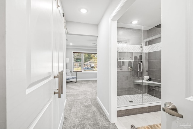 bathroom featuring a shower with shower door