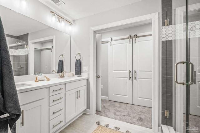 bathroom with vanity and a shower with shower door