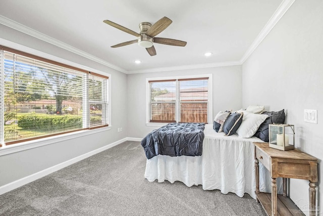 carpeted bedroom with crown molding, multiple windows, and ceiling fan