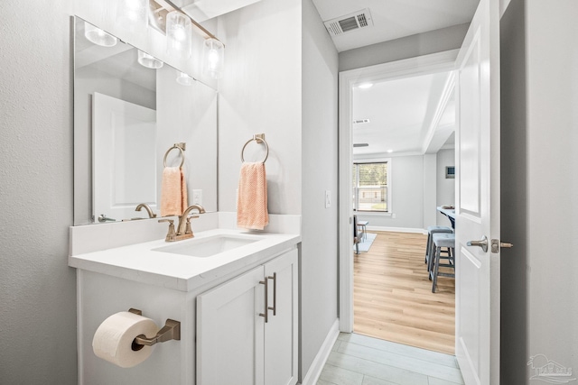 bathroom featuring vanity and hardwood / wood-style floors