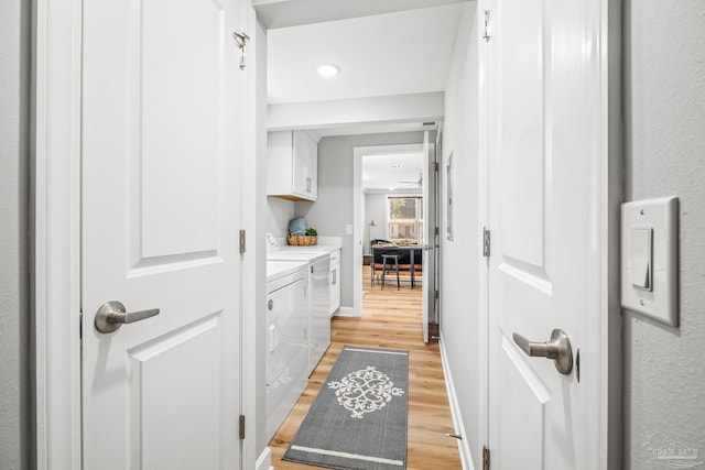 interior space with separate washer and dryer, vanity, and hardwood / wood-style floors