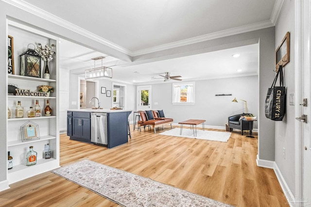 interior space with pendant lighting, light hardwood / wood-style floors, crown molding, and stainless steel dishwasher