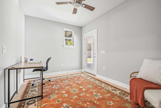 home office with ceiling fan and light hardwood / wood-style flooring