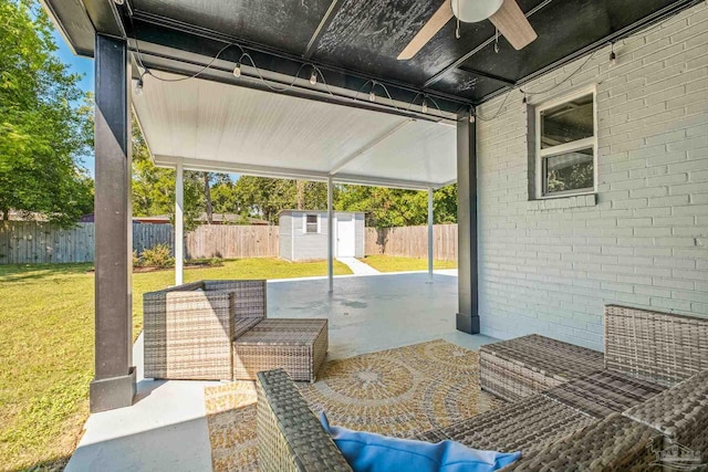 view of patio / terrace with ceiling fan and a shed