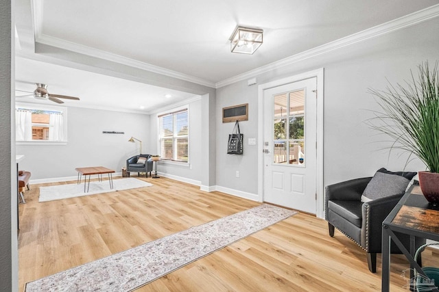 entryway featuring ceiling fan, ornamental molding, and hardwood / wood-style floors