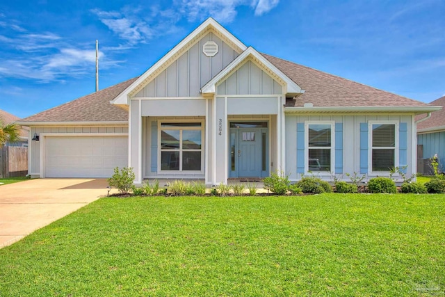 3564 Sailfish Dr, Gulf Breeze, FL 32563 - view of front of house featuring board and batten siding, a shingled roof, a garage, and a front yard
