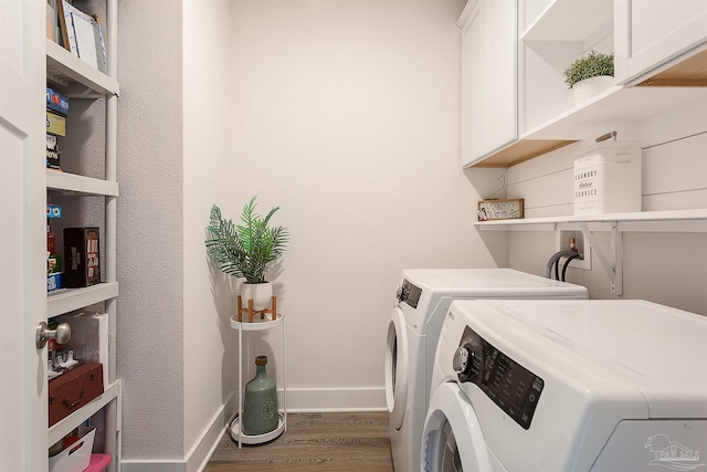 3564 Sailfish Dr, Gulf Breeze, FL 32563 - laundry room with cabinet space, washer and clothes dryer, and wood finished floors