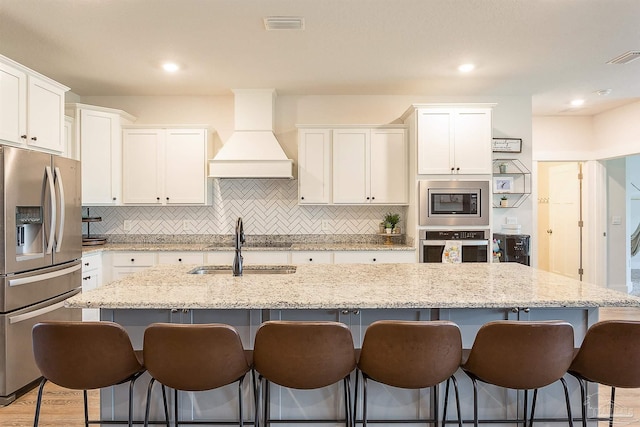 3564 Sailfish Dr, Gulf Breeze, FL 32563 - kitchen featuring appliances with stainless steel finishes, custom exhaust hood, white cabinets, and recessed lighting