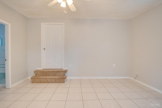 4117 Pace Ln, Pace, FL 32571 - empty room with a ceiling fan, a textured ceiling, and light tile patterned flooring