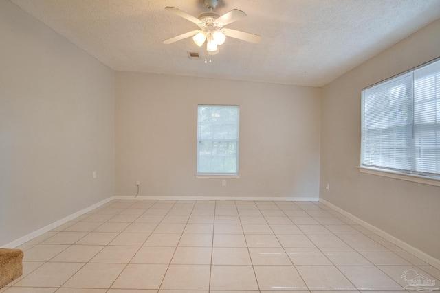 4117 Pace Ln, Pace, FL 32571 - unfurnished room featuring plenty of natural light, a textured ceiling, a ceiling fan, and light tile patterned flooring