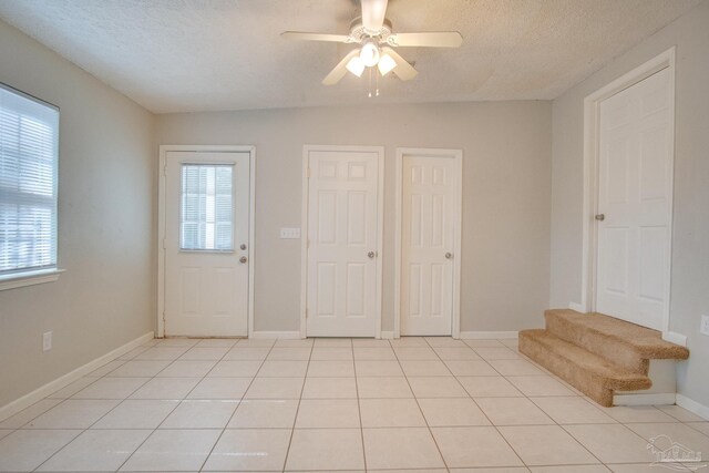 4117 Pace Ln, Pace, FL 32571 - entrance foyer with a ceiling fan, a textured ceiling, and light tile patterned floors
