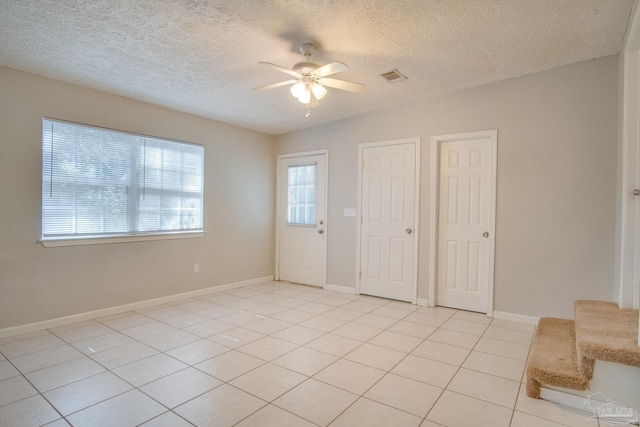 4117 Pace Ln, Pace, FL 32571 - entrance foyer with a ceiling fan, light tile patterned flooring, and a textured ceiling