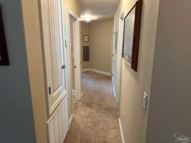 corridor with light colored carpet and baseboards