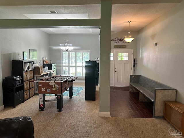 rec room featuring carpet flooring, a chandelier, and baseboards