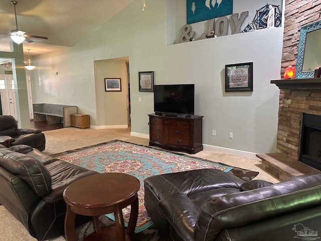 carpeted living room featuring ceiling fan, a fireplace, baseboards, and high vaulted ceiling