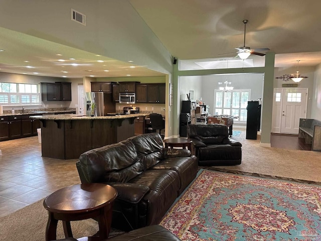 living area with a chandelier, light tile patterned floors, a ceiling fan, and recessed lighting