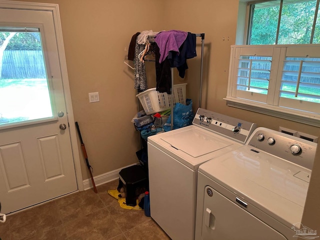 laundry area featuring washing machine and clothes dryer and baseboards
